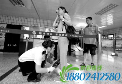 工作人员对每位乘车旅客进行安检。京华时报记者欧阳晓菲摄