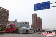 罐车冲上隔离带后侧翻 载数十吨沥青罐体脱落